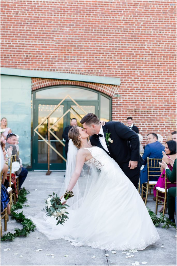 Bride and groom kissing at morean center for clay