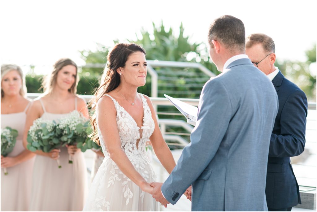 bride smiling at groom during ceremony at clearwater beach