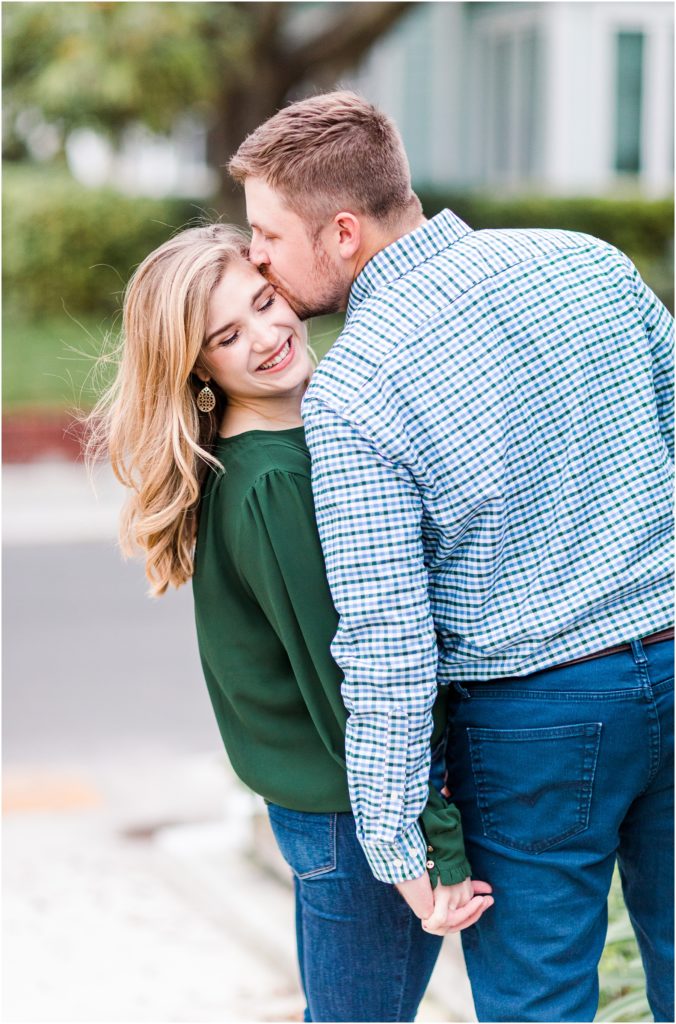 a guy kissing a girl in south tampa engagement session