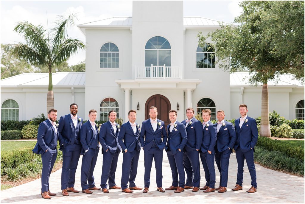 groomsmen in navy suits and pink bow ties at clearwater wedding