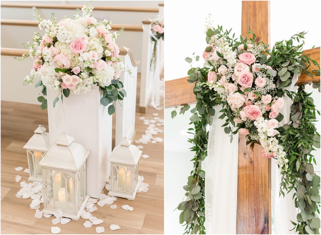 the cross decorated with pink flowers in white wedding chapel
