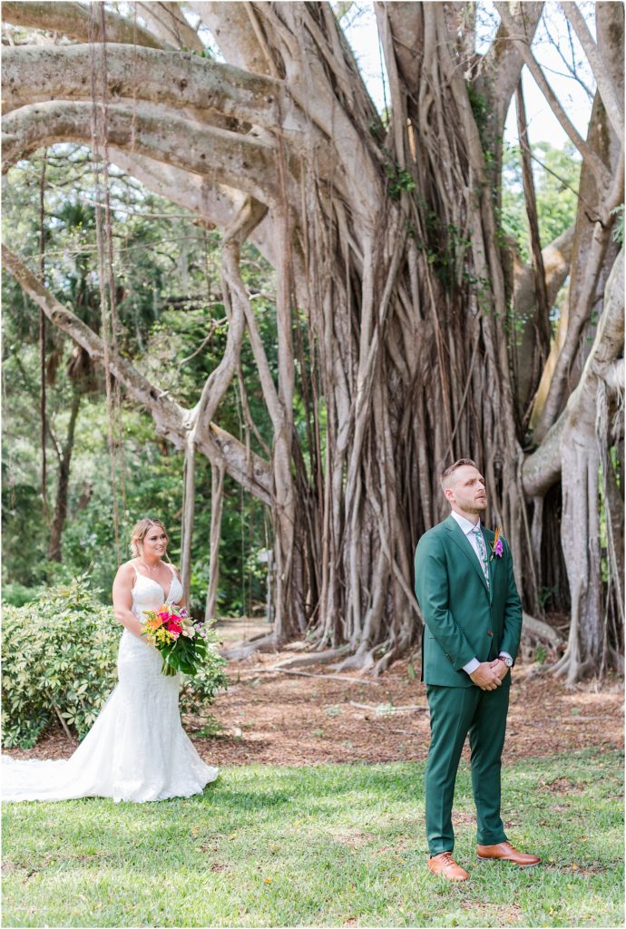 a bride and groom first look underneath the banyan tree at powel crosley estate