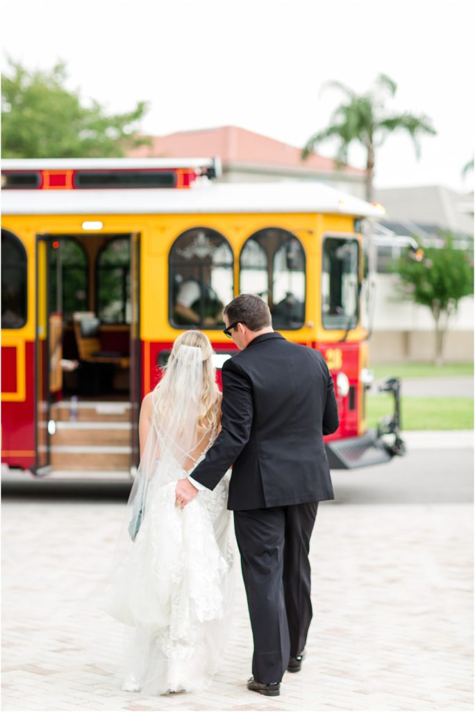 bride and groom kissing by jolly trolley in dunedin florida wedding