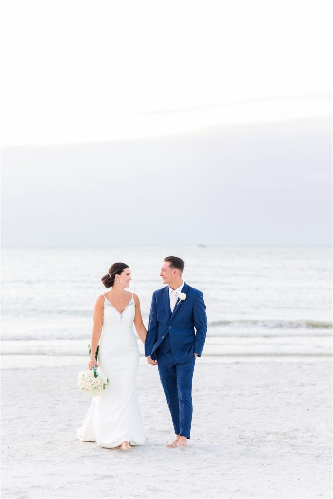 bride and groom walking on clearwater beach