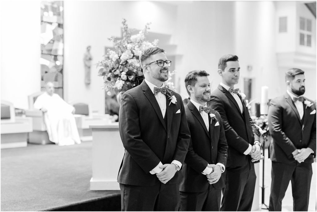 groom seeing bride for the first time at Resurrection Catholic Church lakeland