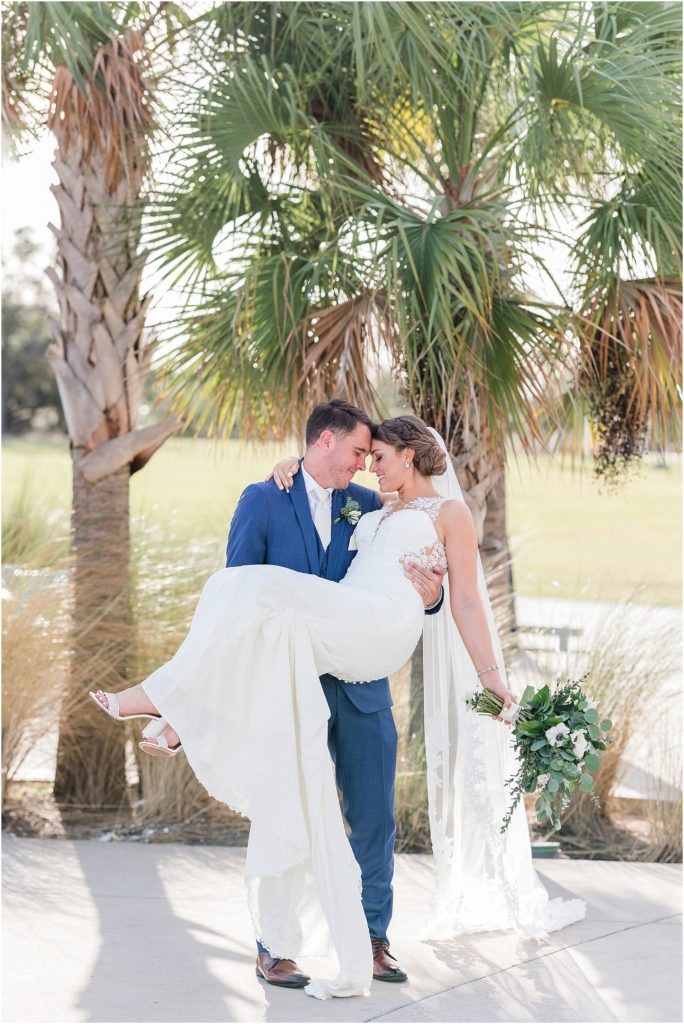 a romantic image of bride and groom with palm trees at tampa river center