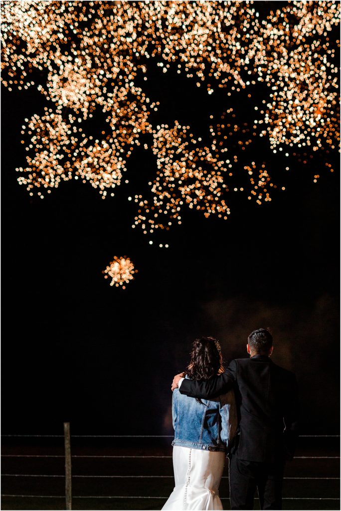couple watching fireworks at a lakewood ranch wedding