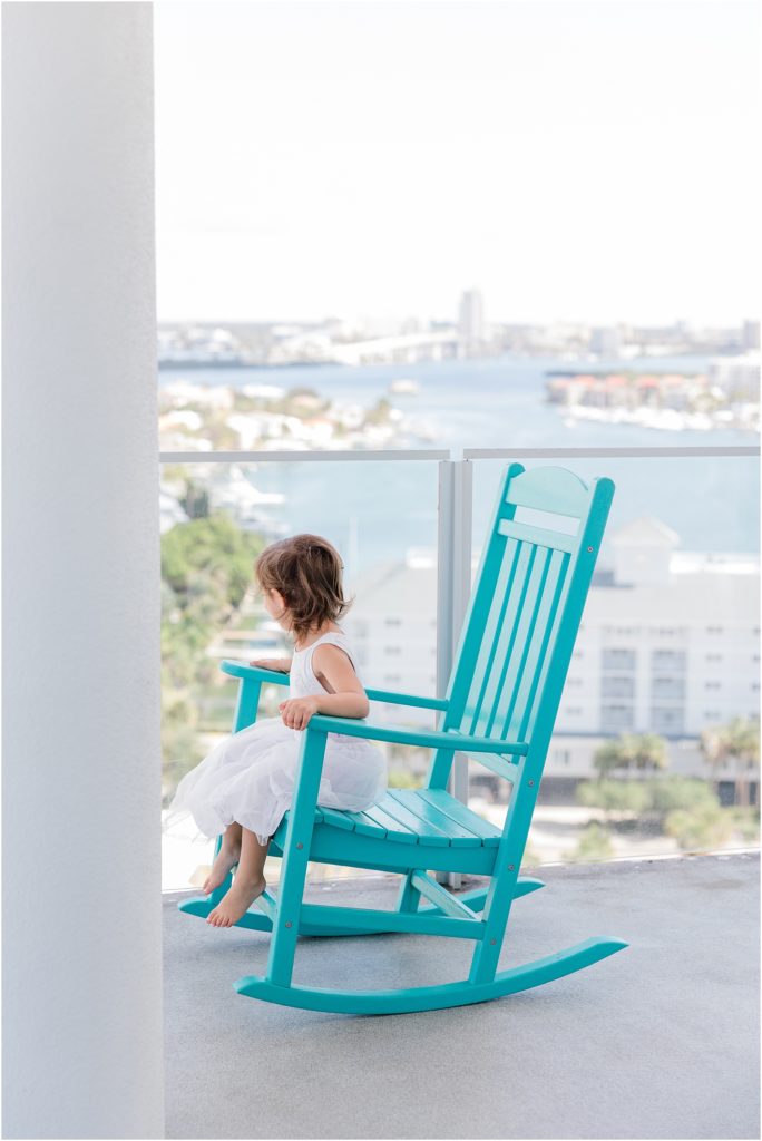 little girl sitting on the porch at clearwater beach