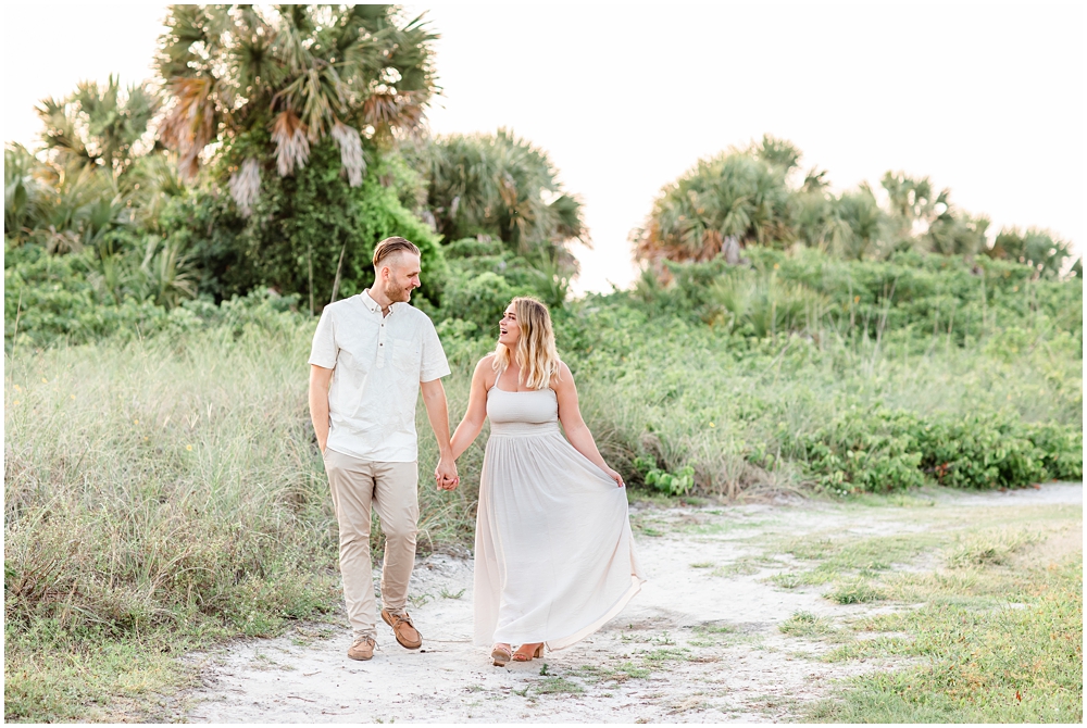 couple holding hands walking at fort desoto for engagement session