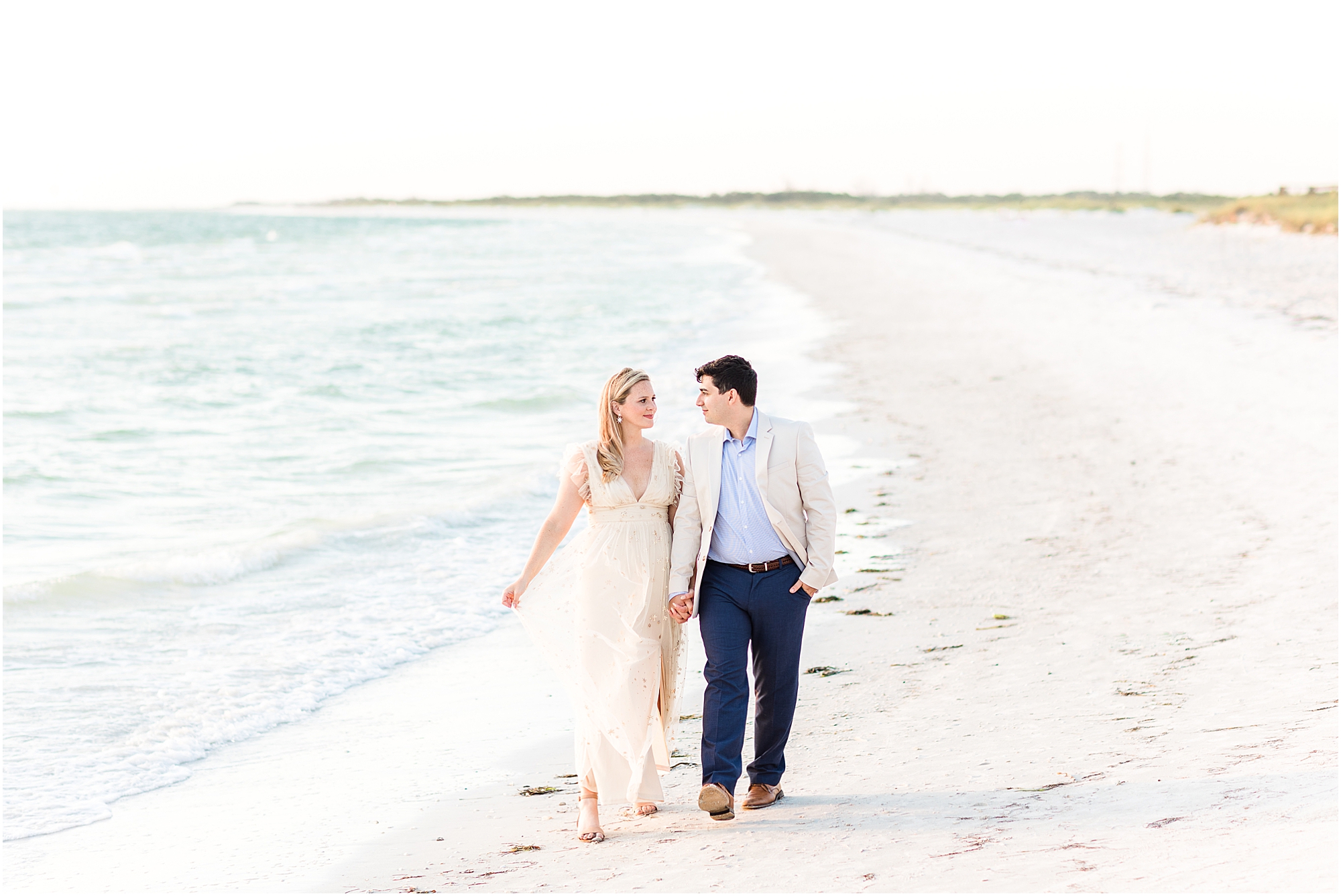 couple walking on the beach at fort desoto in florida
